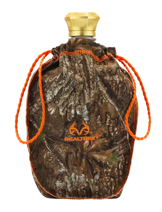 The Crown Royal x REALTREE Deluxe Limited Edition features a gold-capped flask in a Realtree camo pouch with orange drawstrings and the Crown Royal logo—celebrating Canadian whisky style.