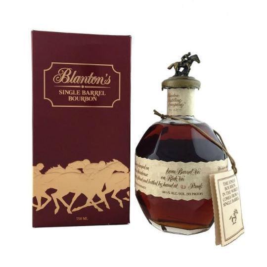 A bottle of Blanton's Bourbon Special Reserve Takara Red Label 93 Proof, a Japanese import, featuring its iconic horse and jockey stopper and displayed next to a maroon box with galloping horse silhouettes.