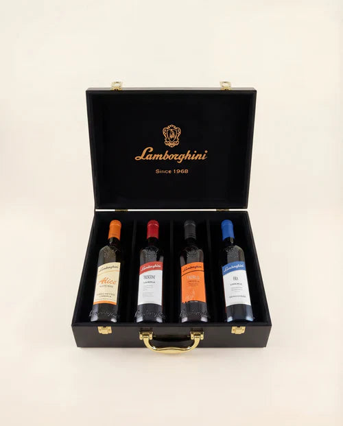The Lamborghini Ultimate Wine Gift Set by Lamborghini Wine & Spirits Collections features four wines—Trescone, Era, Taurus, and Alice—in a black luxury gift case with gold accents, each bottle sporting a unique label for an exquisite Italian present.