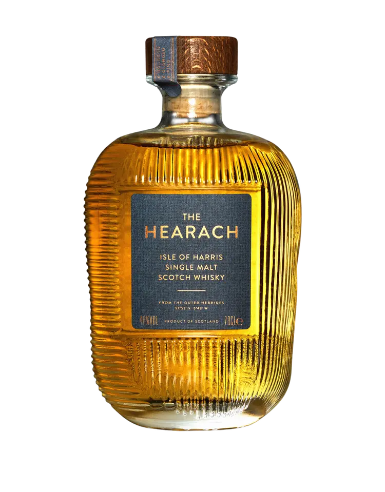 A bottle of The Hearach Isle of Harris Single Malt Scotch Whisky by The Hearach, featuring a ribbed glass design and a blue and copper label.