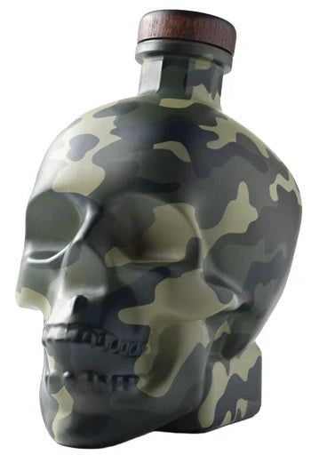 Crystal Head Vodka Camo Veteran Tribute Limited Edition features a striking green and black camouflage skull-shaped bottle with a dark wooden cap, crafted by Crystal Head Vodka.