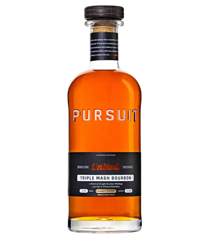 A 700mL bottle of Pursuit United Barrel Proof Triple Mash Bourbon from Pursuit Spirits features amber liquid in clear glass, a wooden cap, and a black label with orange and white brand and product details.