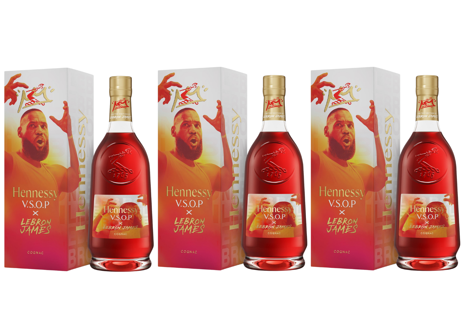 Three Hennessy V.S.O.P x LeBron James Limited Edition Cognac bottles stand before boxes featuring LeBron's raised arm and a bold red-and-yellow design, highlighting this unique Hennessy tribute to the basketball legend.