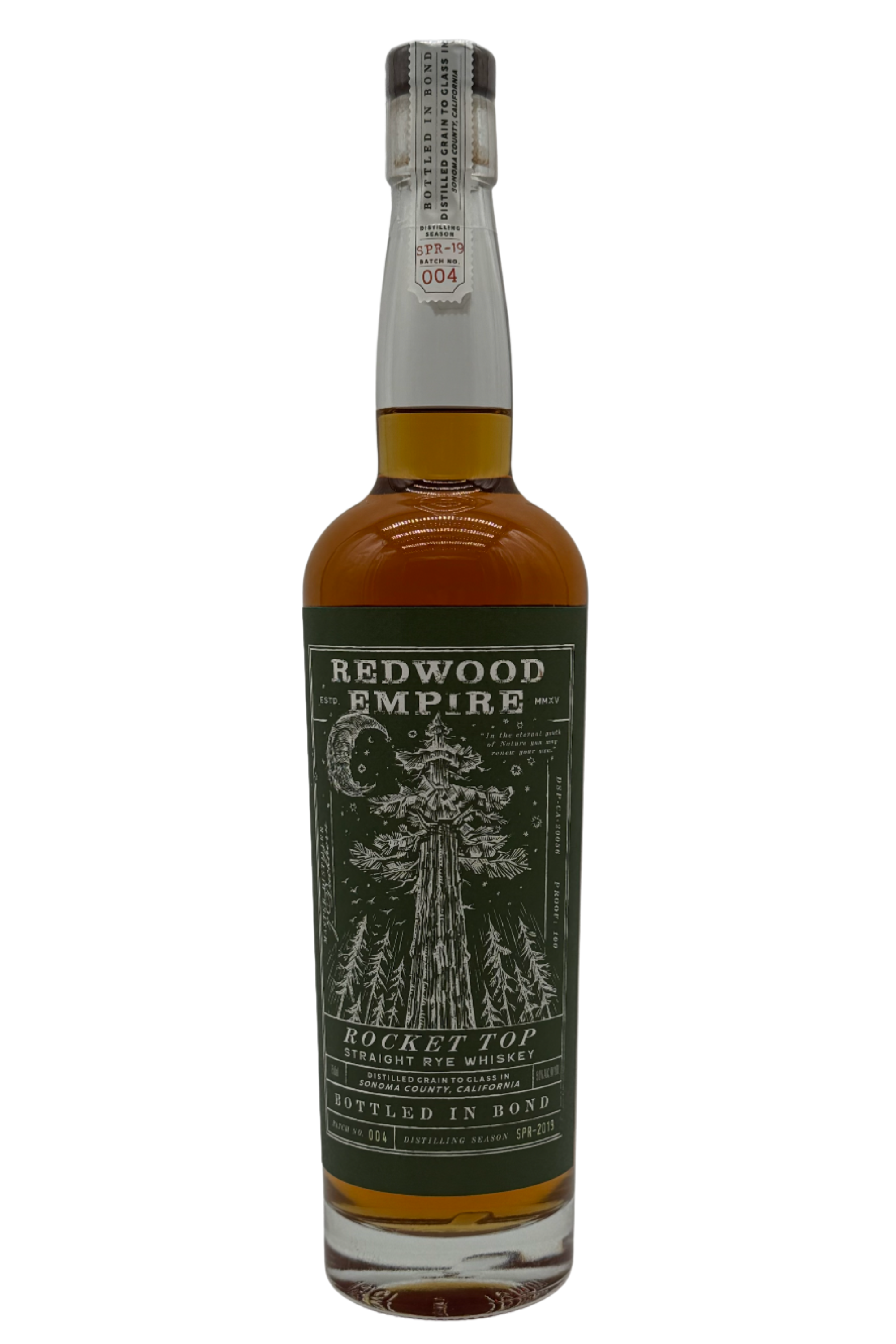 A bottle of Redwood Empire Rocket Top Bottled in Bond Straight Rye Whiskey Batch 004 2025 Release by Redwood Empire Whiskey, from Sonoma County, with a green label depicting a tall redwood tree, forest, moon, clear wrapper, and white cap label.