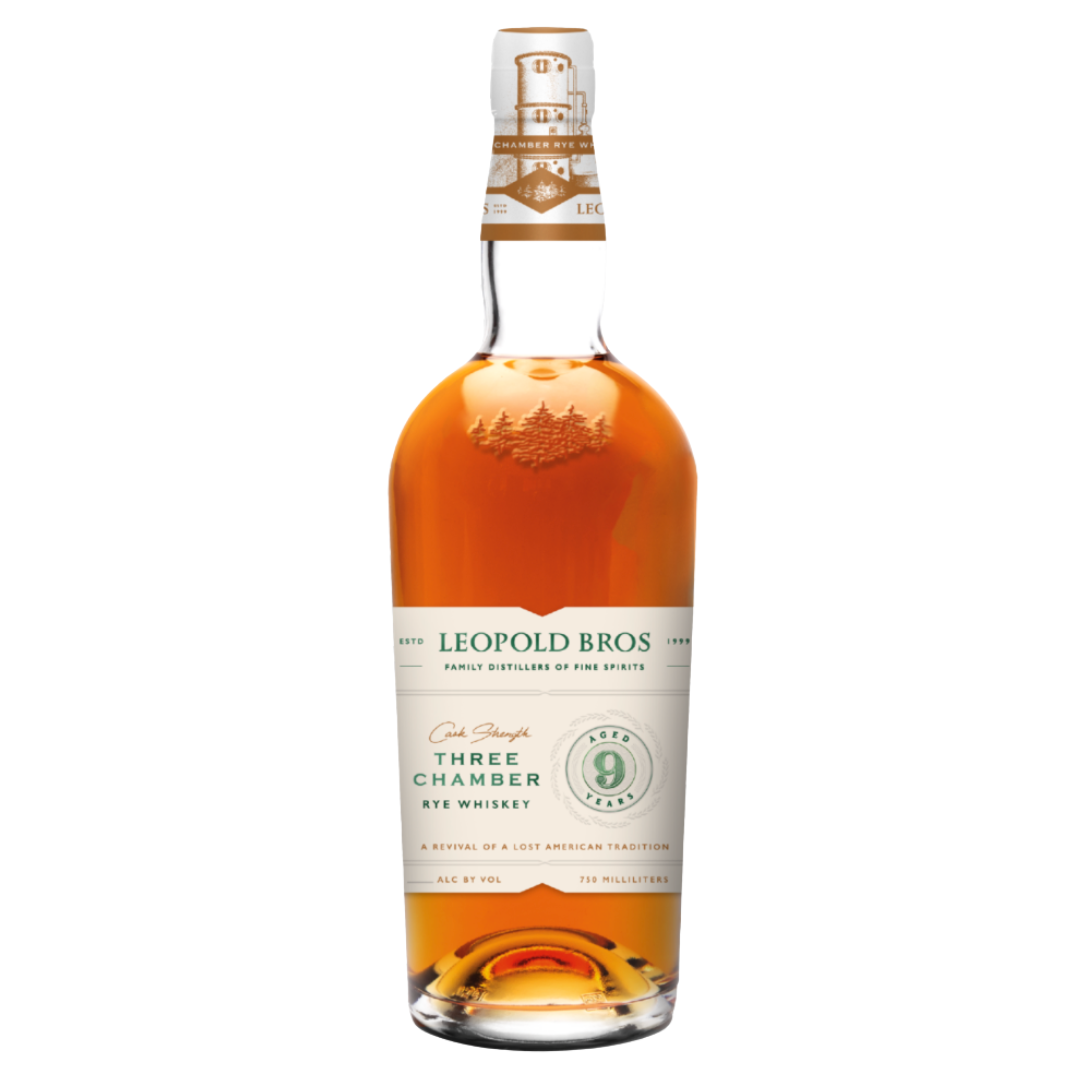 A bottle of Leopold Bros 9 Year Three Chamber Rye Whiskey Cask Strength Revival (PRE-ORDER) with amber liquid, white and green label, gold accents, a pine tree illustration, and “Three Chamber Rye Whiskey” highlighted for its 9-year aged rye heritage.